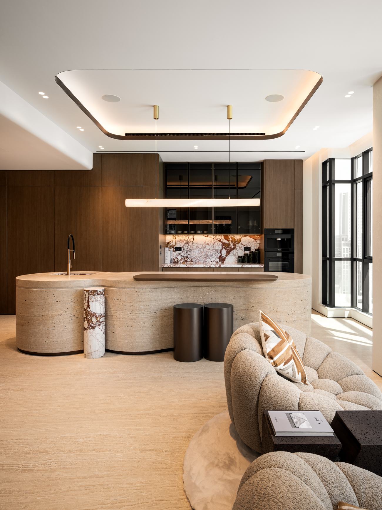 Burj Khalifa View Penthouse — curved travertine island in the open kitchen
