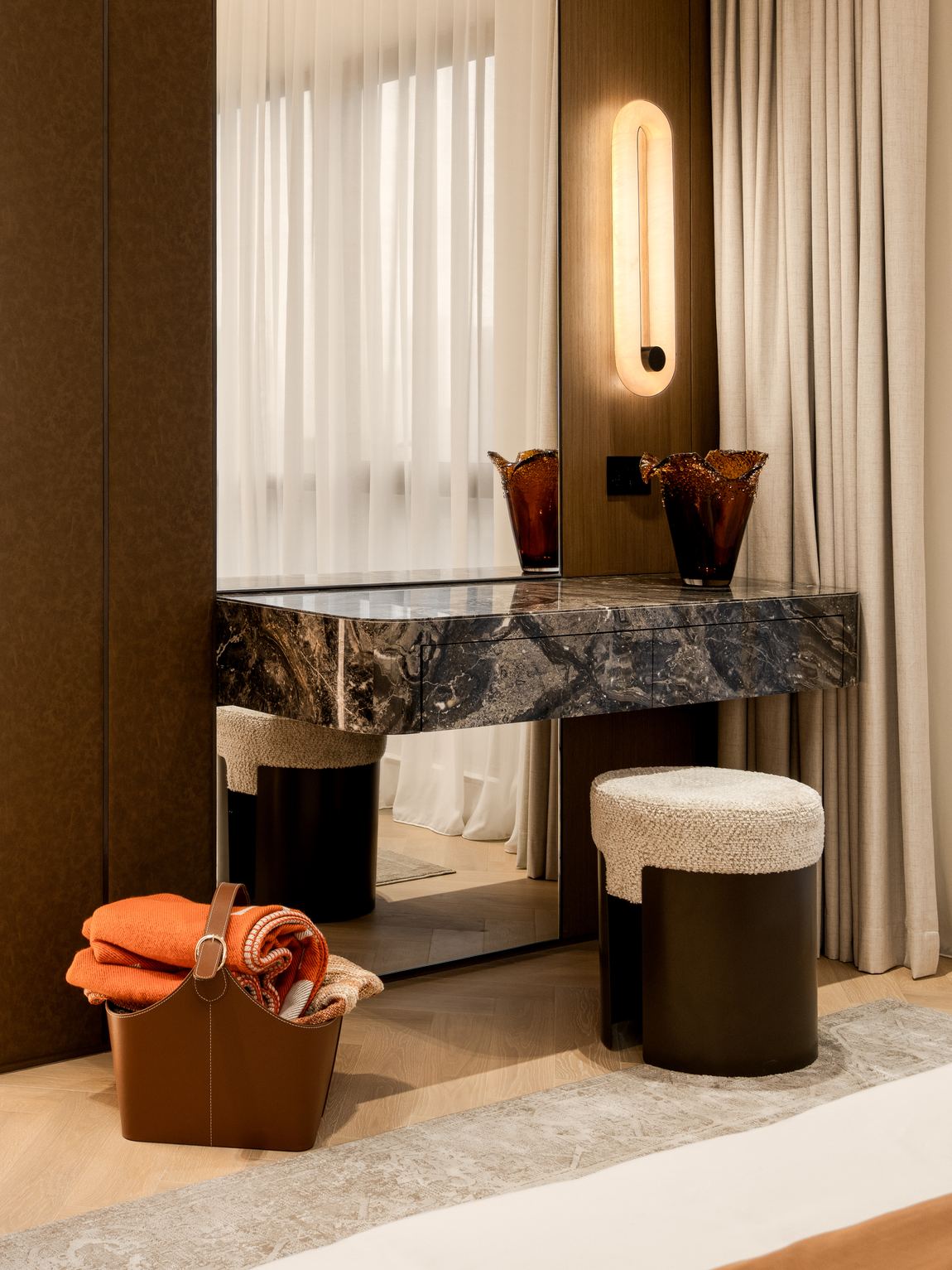 Dressing table in dark figured marble with an alabaster wall light